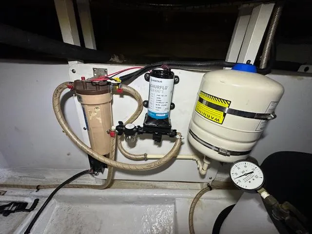 Tortuga Yacht Photos Pics 1987 Kadey-Krogen 42 boat engine compartment with water filtration and pressure system components.