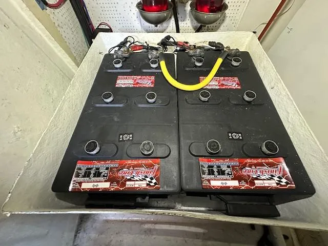 Tortuga Yacht Photos Pics Batteries in a 1987 Kadey-Krogen 42 engine room, with red warning lights above.