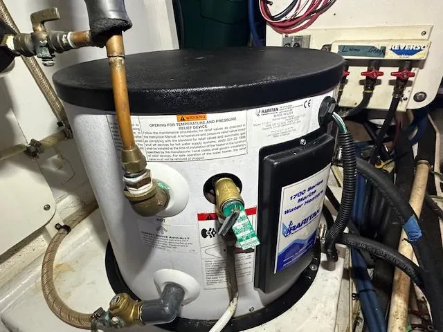 Tortuga Yacht Photos Pics Water heater in 1987 Kadey-Krogen 42 boat engine room, with pipes and wiring connections.