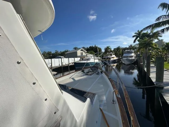 Tortuga Yacht Photos Pics 1987 Kadey-Krogen 42 yacht docked in a sunny marina with palm trees.