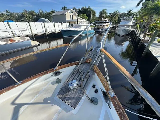 Tortuga Yacht Photos Pics 1987 Kadey-Krogen 42 boat docked in a serene marina with surrounding yachts.