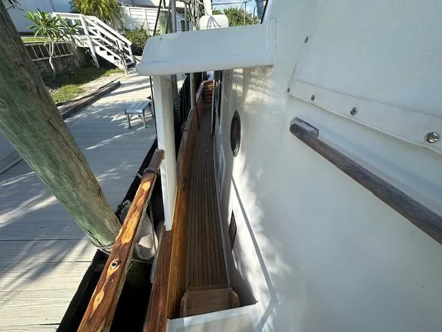 Tortuga Yacht Photos Pics 1987 Kadey-Krogen 42 yacht side deck with wooden railing and dock view.