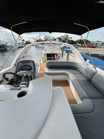  Yacht Photos Pics 2004 Meridian 381 yacht with spacious deck, seating, and helm, docked at marina.