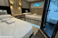 Luxurious 2024 Custom 29m Charter MY cabin with twin beds and ensuite bathroom.