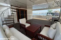Luxurious 2024 Custom 29m Charter MY yacht deck with elegant seating and spiral staircase.