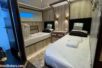 Luxurious twin bedroom on 2024 Custom 29m Charter MY yacht, featuring modern decor and ambient lighting.