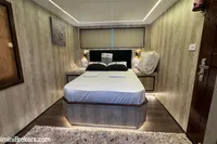 Luxurious bedroom interior on 2024 Custom 29m Charter MY yacht, featuring modern design and ambient lighting.