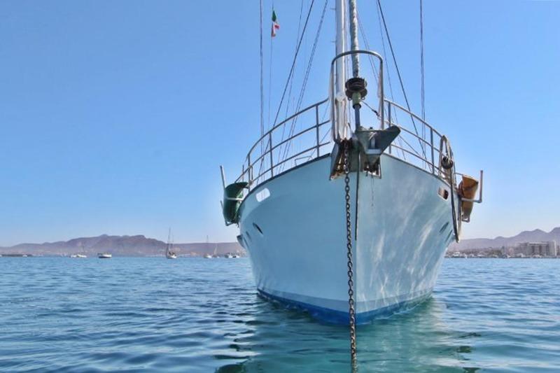 Custom 1991 Centre Cockpit Pilot House Steel Cutter Motorsailer anchored in calm waters.