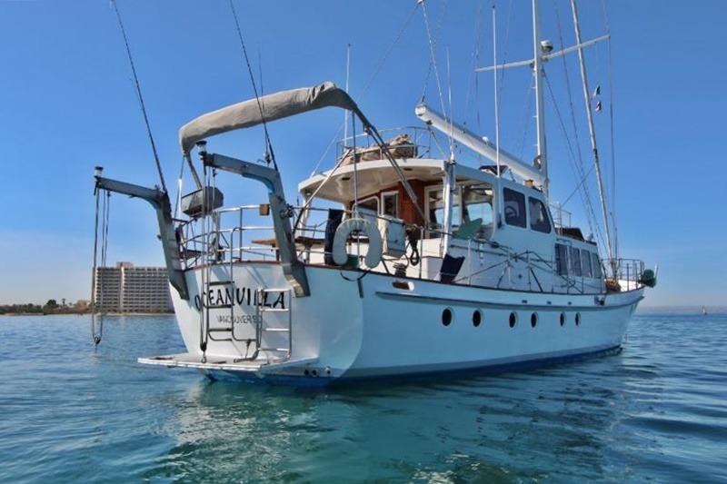 Custom 1991 Centre Cockpit Pilot House Steel Cutter Motorsailer on calm blue water.