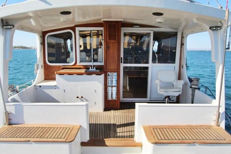 Ocean Villa Yacht Photos Pics Centre cockpit of 1991 Custom Motorsailer with wood accents and ocean view.