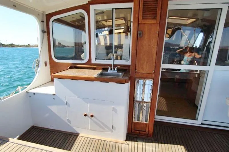 Ocean Villa Yacht Photos Pics Centre cockpit pilot house with sink on 1991 steel cutter motorsailer, overlooking ocean.