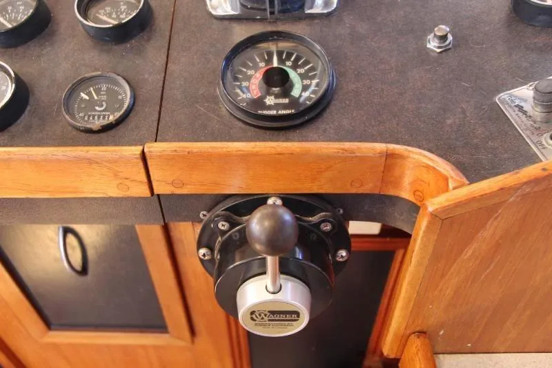 Ocean Villa Yacht Photos Pics Centre cockpit control panel of 1991 steel cutter motorsailer with gauges and lever.
