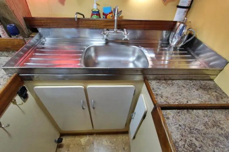 Ocean Villa Yacht Photos Pics Stainless steel sink in 1991 Custom Centre Cockpit Pilot House Motorsailer kitchen.