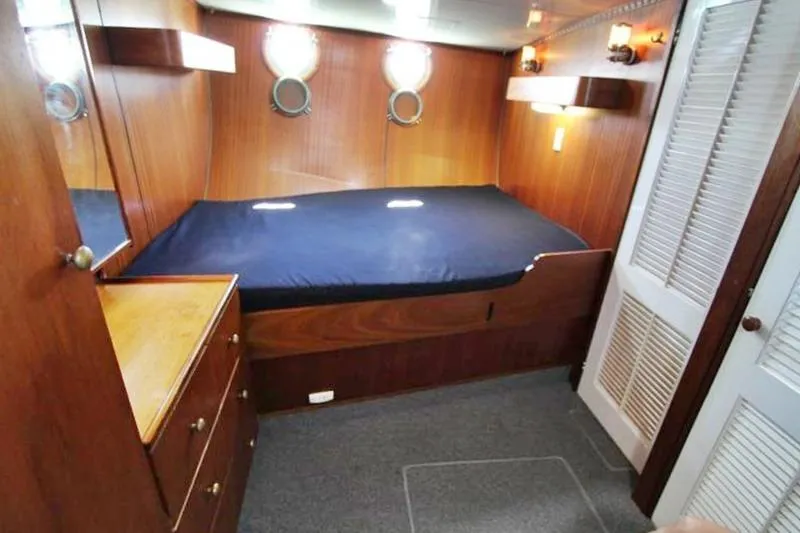 Ocean Villa Yacht Photos Pics Cozy cabin interior of 1991 Custom Centre Cockpit Motorsailer with wood paneling and portholes.