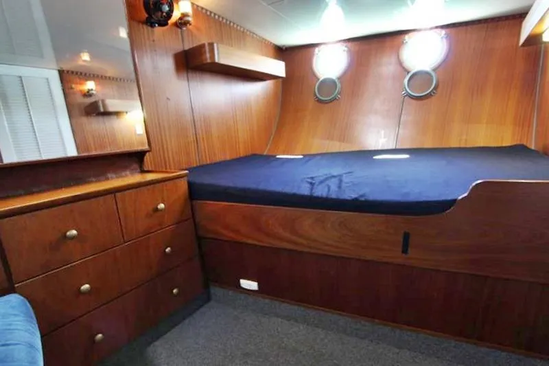 Ocean Villa Yacht Photos Pics Cozy cabin interior of 1991 Custom Centre Cockpit Motorsailer with wood paneling and portholes.