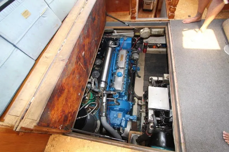 Ocean Villa Yacht Photos Pics Engine room of 1991 Custom Centre Cockpit Pilot House Steel Cutter Motorsailer, showcasing blue machinery.