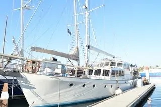 Ocean Villa Yacht Photos Pics Custom 1991 Centre Cockpit Pilot House Steel Cutter Motorsailer docked at marina.