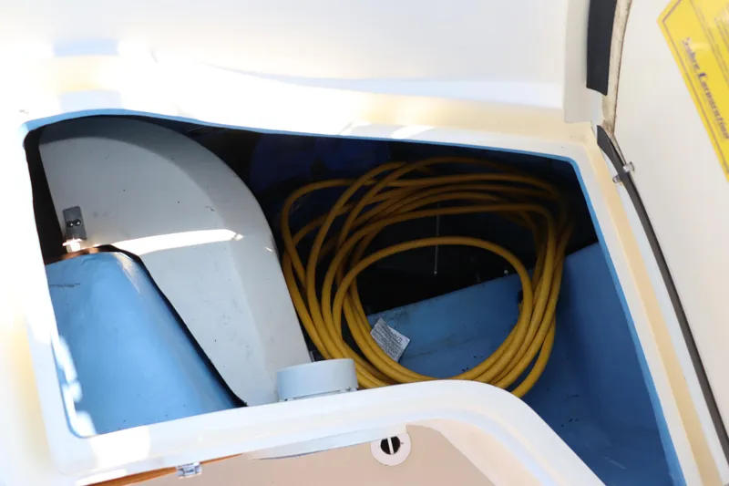 Cianna Yacht Photos Pics Storage compartment in a 2001 Sabre 402 boat with coiled yellow rope.