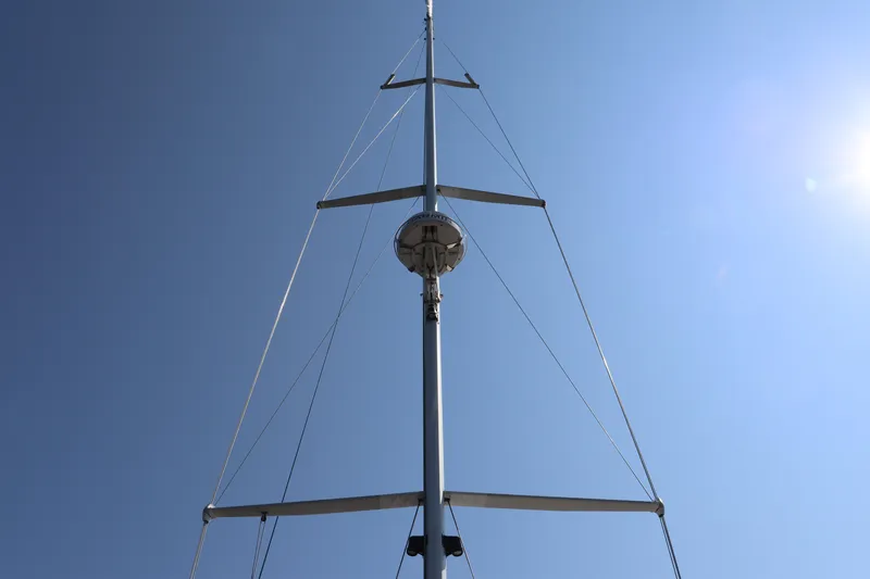 Cianna Yacht Photos Pics Mast of 2001 Sabre 402 sailboat against clear blue sky.