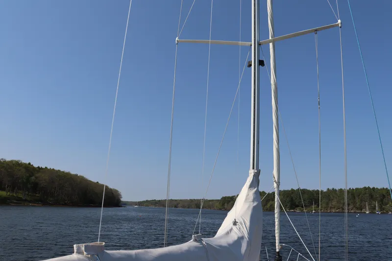 Cianna Yacht Photos Pics Sailing on a Sabre 402 yacht, 2001 model, on a calm river under a clear blue sky.