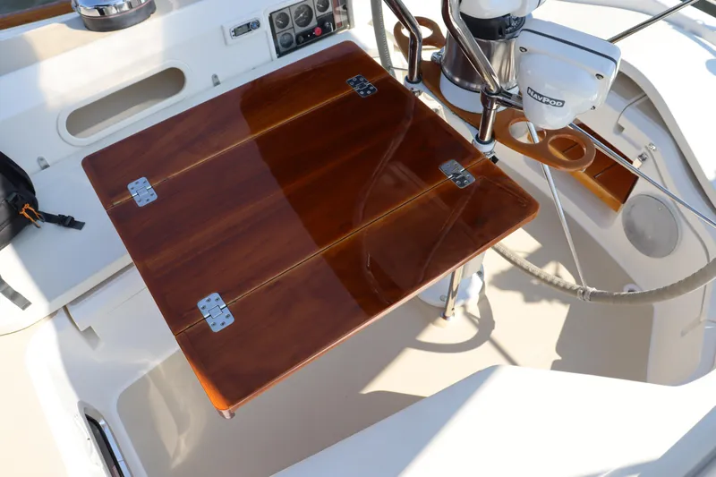 Cianna Yacht Photos Pics Cockpit of 2001 Sabre 402 sailboat with wooden folding table and navigation equipment.