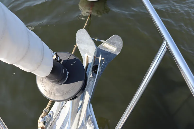 Cianna Yacht Photos Pics Bow of 2001 Sabre 402 sailboat with anchor and railing over water.