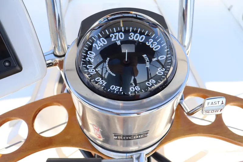 Cianna Yacht Photos Pics Compass on 2001 Sabre 402 yacht, featuring a Ritchie navigation system and wooden steering wheel.