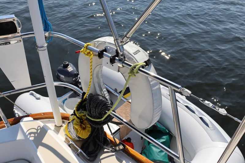 Cianna Yacht Photos Pics Sailboat deck with lifebuoy and ropes, Sabre 402, 2001 model, on calm water.
