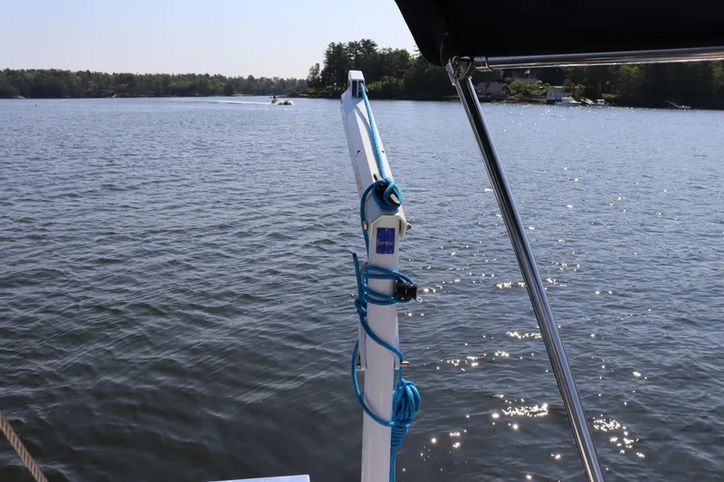 Cianna Yacht Photos Pics Sailboat deck view on water, Sabre 402, 2001 model, with blue rope and scenic background.