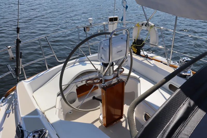 Cianna Yacht Photos Pics 2001 Sabre 402 sailboat cockpit with steering wheel, on calm water.