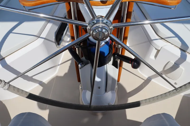 Cianna Yacht Photos Pics Steering wheel of a 2001 Sabre 402 sailboat, featuring polished metal and wooden accents.