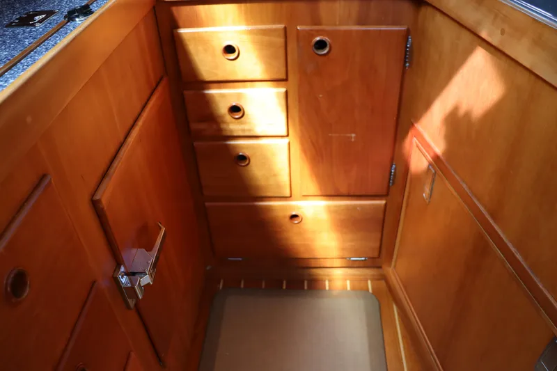 Cianna Yacht Photos Pics Wooden cabinetry inside a 2001 Sabre 402 boat, featuring drawers and a small door.