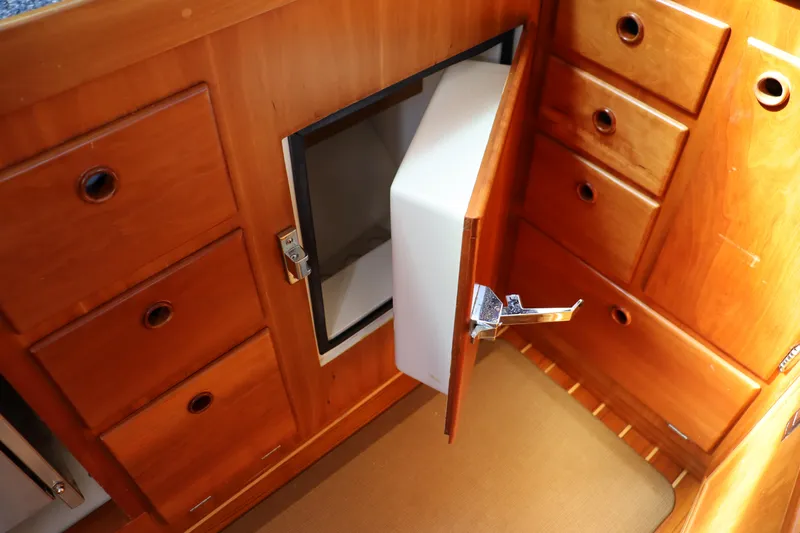 Cianna Yacht Photos Pics Wooden cabinetry with open fridge door in 2001 Sabre 402 yacht interior.