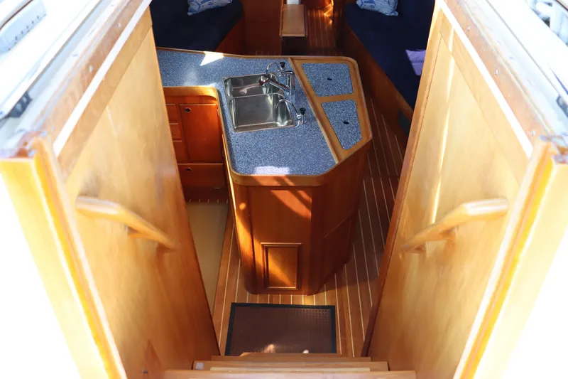 Cianna Yacht Photos Pics Interior view of 2001 Sabre 402 yacht kitchen with wooden cabinetry and sink.