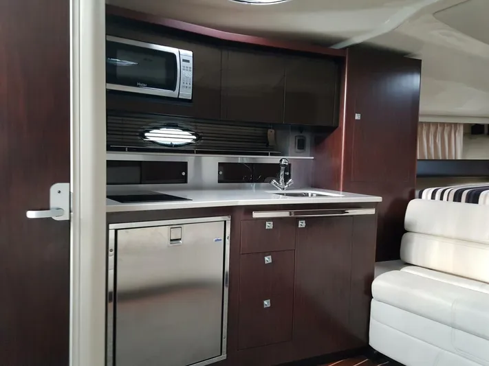  Yacht Photos Pics Interior of 2013 Monterey 340 Sport Yacht with kitchenette and seating area.