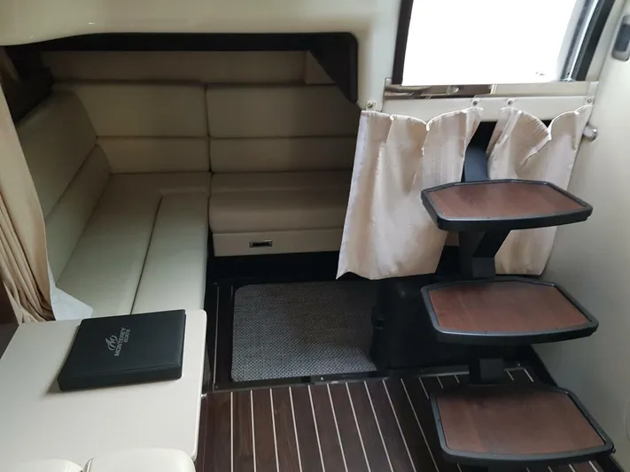  Yacht Photos Pics Interior of 2013 Monterey 340 Sport Yacht with seating and wooden steps.