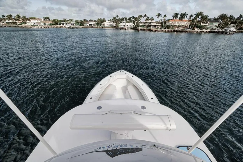 Southpaw Yacht Photos Pics Bahama 41' 2015 boat on calm water with waterfront homes in the background.