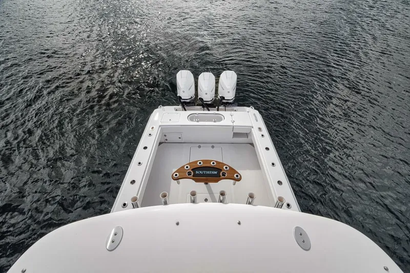 Southpaw Yacht Photos Pics Bahama 41' 2015 boat with triple outboard motors on water.