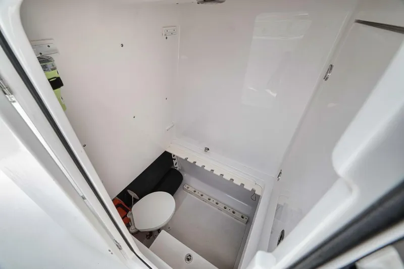 Southpaw Yacht Photos Pics Compact bathroom in 2015 Bahama 41' boat, featuring a toilet and storage space.