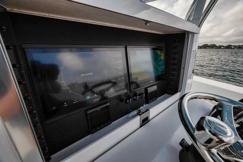 Southpaw Yacht Photos Pics 2015 Bahama 41' boat dashboard with navigation screens and steering wheel.