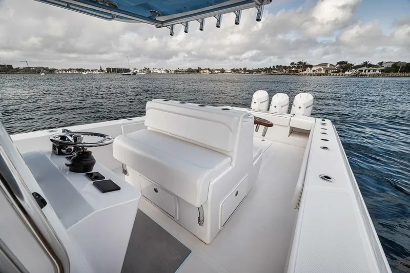 Southpaw Yacht Photos Pics 2015 Bahama 41' boat with spacious deck and seating on calm waters.