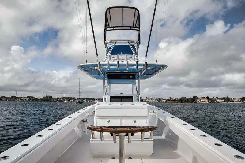 Southpaw Yacht Photos Pics 2015 Bahama 41' boat on water, featuring spacious deck and tower under cloudy sky.