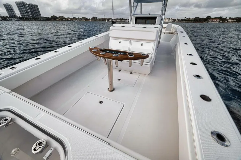Southpaw Yacht Photos Pics 2015 Bahama 41' boat with spacious deck and fishing rod holders on calm water.