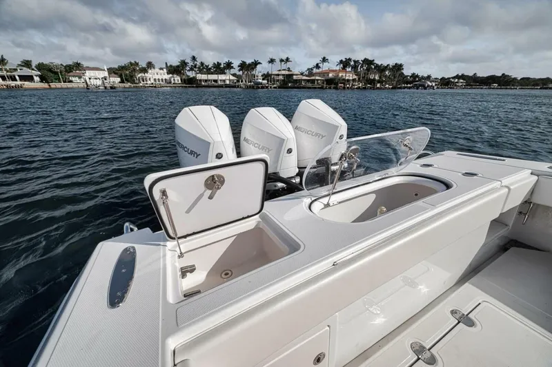 Southpaw Yacht Photos Pics 2015 Bahama 41' boat with triple Mercury engines on a calm waterway.