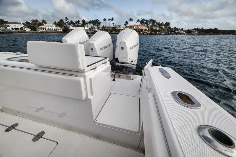 Southpaw Yacht Photos Pics 2015 Bahama 41' boat with triple Mercury engines on a calm sea.