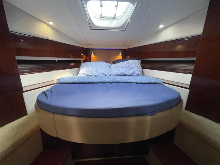  Yacht Photos Pics Luxurious cabin interior of 2010 Sea Ray 450 Sundancer yacht with skylight and cozy bedding.