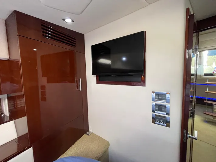  Yacht Photos Pics Interior of 2010 Sea Ray 450 Sundancer with wall-mounted TV and control panels.