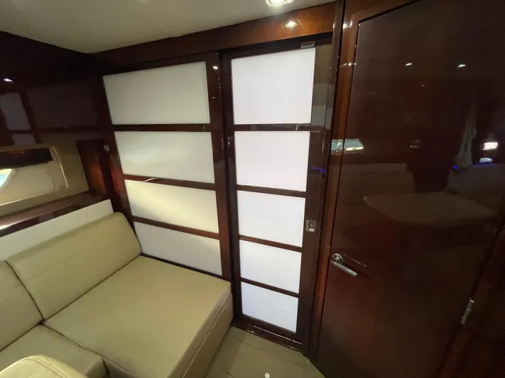  Yacht Photos Pics Interior of 2010 Sea Ray 450 Sundancer with modern wood paneling and beige seating.