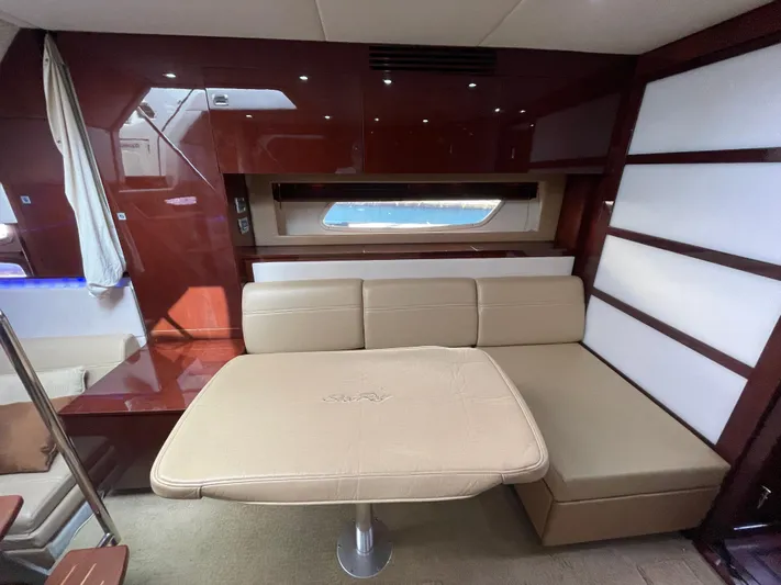  Yacht Photos Pics Interior of 2010 Sea Ray 450 Sundancer yacht with beige seating and wooden accents.