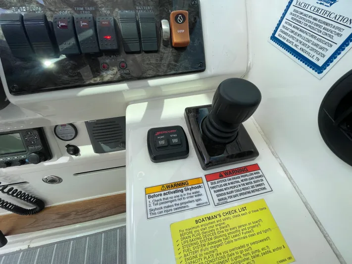  Yacht Photos Pics Control panel of a 2010 Sea Ray 450 Sundancer yacht with joystick and warning labels.